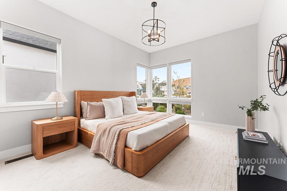 Bedroom featuring baseboards and a chandelier