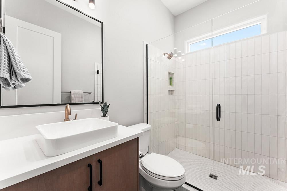 Bathroom with a stall shower and vanity