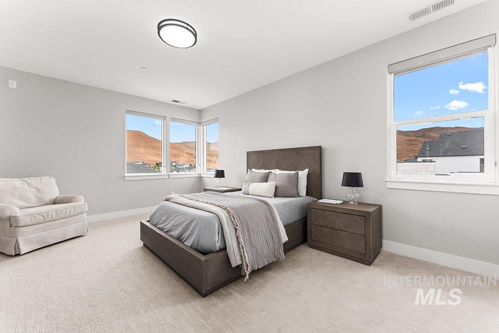 Bedroom with light carpet and baseboards