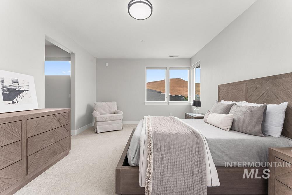 Bedroom featuring light colored carpet and baseboards