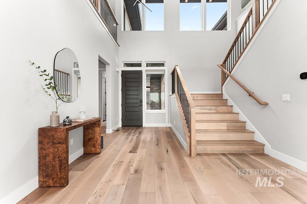 Entrance foyer featuring stairway and light wood-style flooring