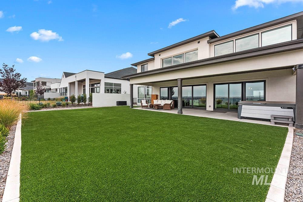 Rear view of house featuring a patio area and stucco siding