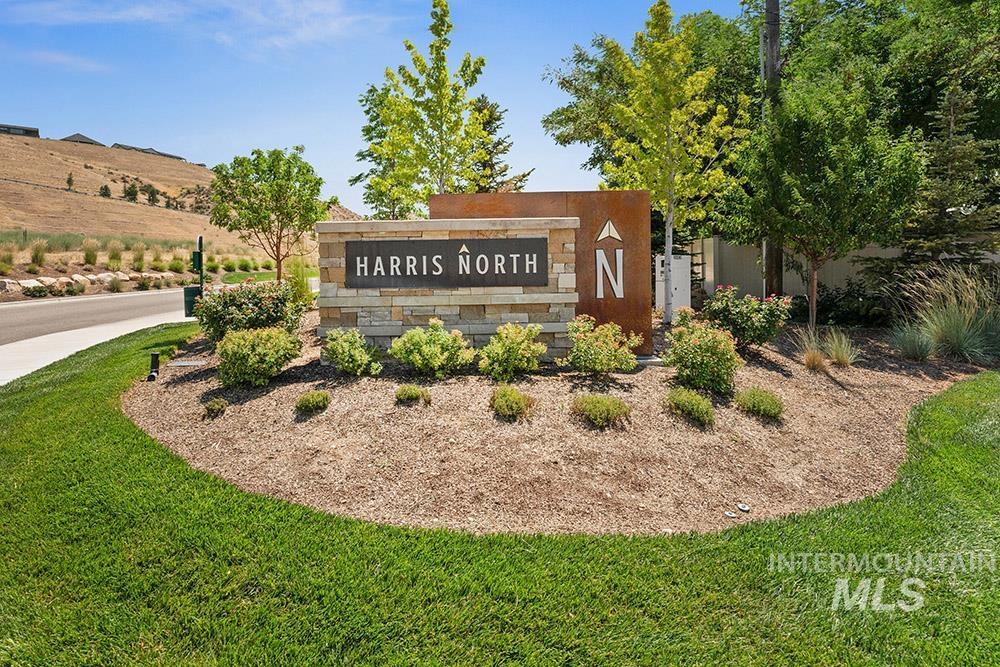 Community / neighborhood sign featuring a lawn