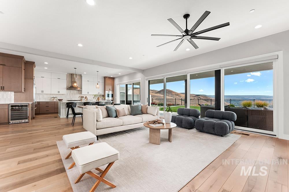 Living room with light wood-type flooring, beverage cooler, recessed lighting, and a mountain view