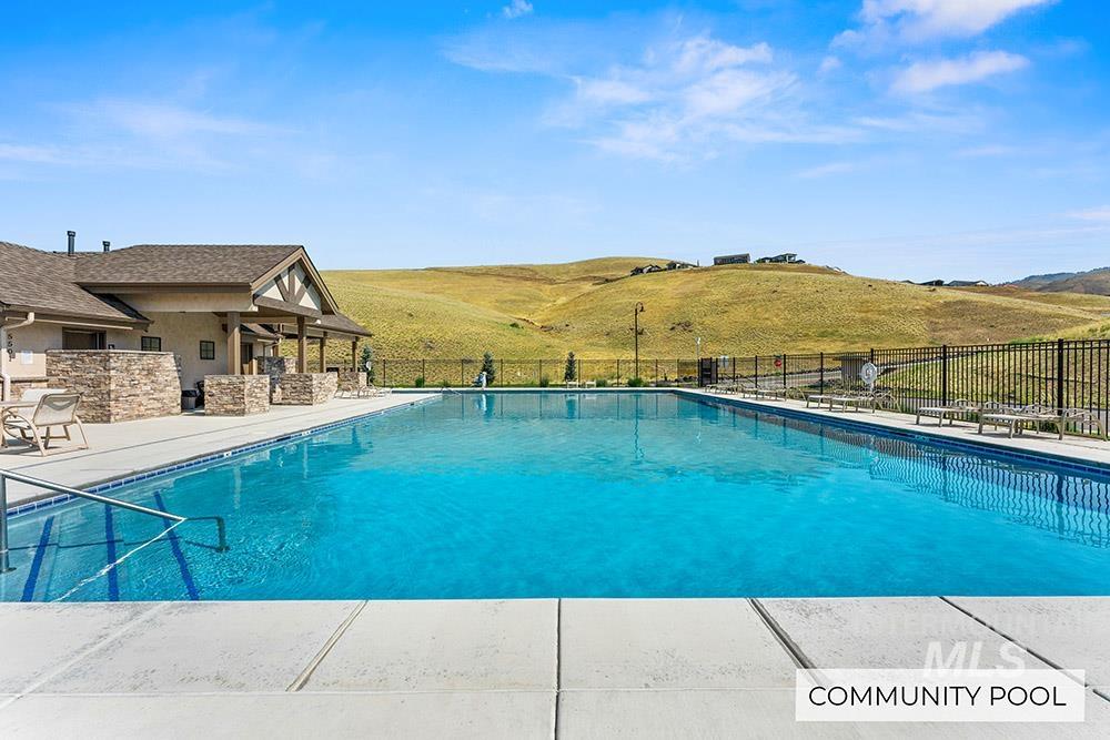 Community pool with a patio area and a mountain view