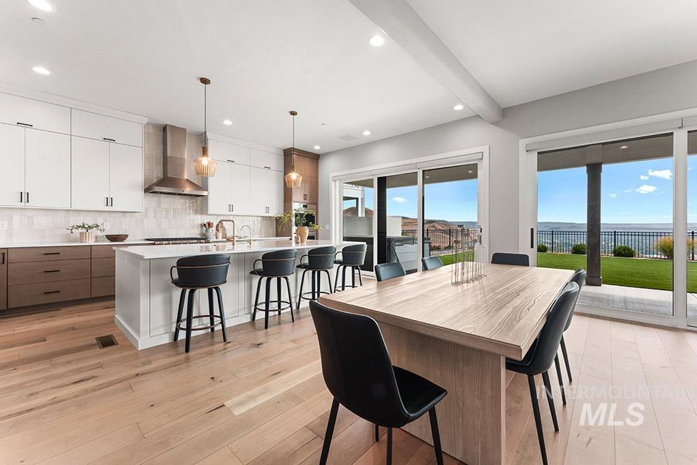 Dining space with beamed ceiling, light wood-type flooring, and recessed lighting