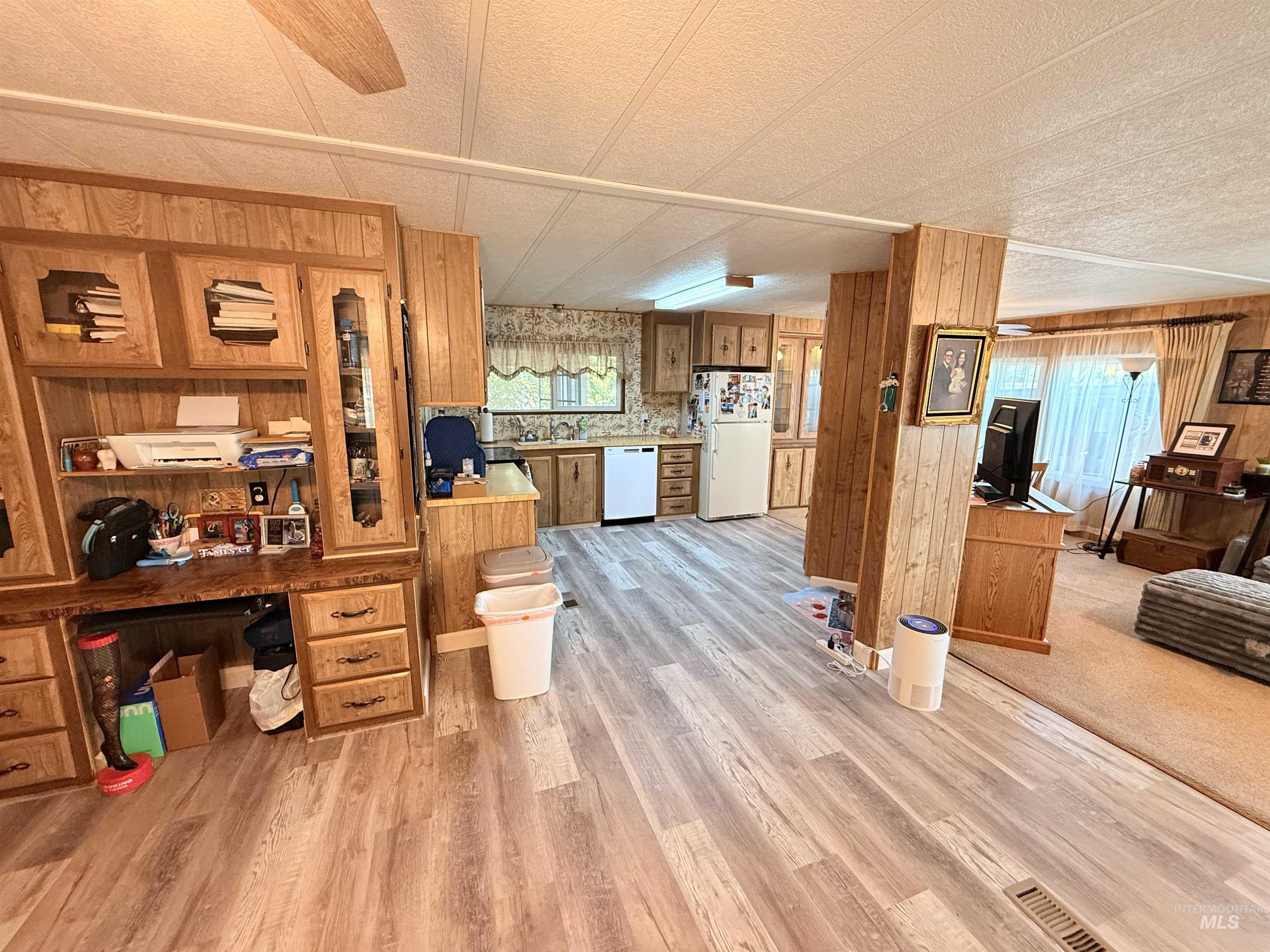 Interior space featuring wood walls, light wood-style floors, and plenty of natural light