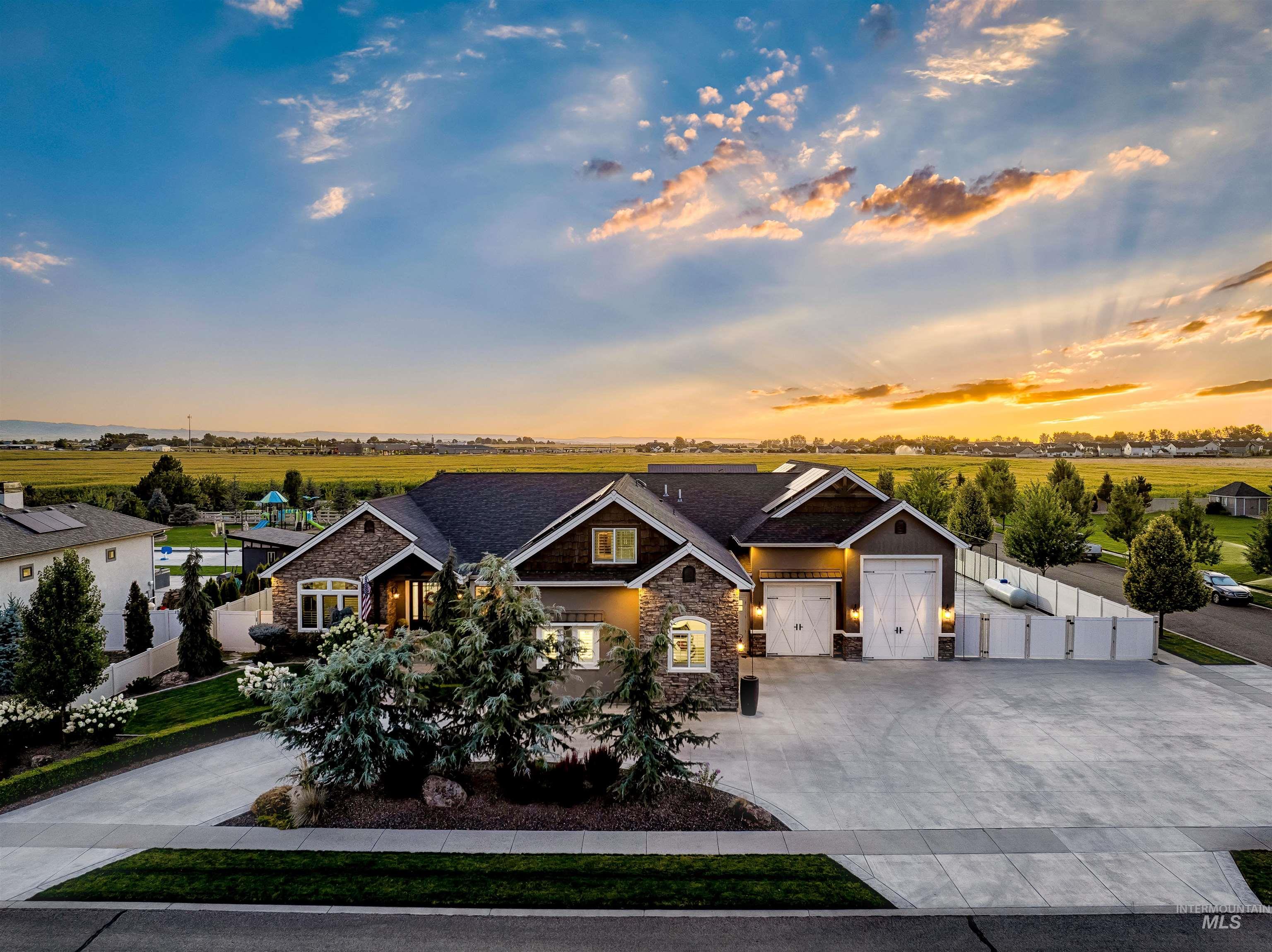 Craftsman inspired home featuring stone siding, concrete driveway, and an attached garage