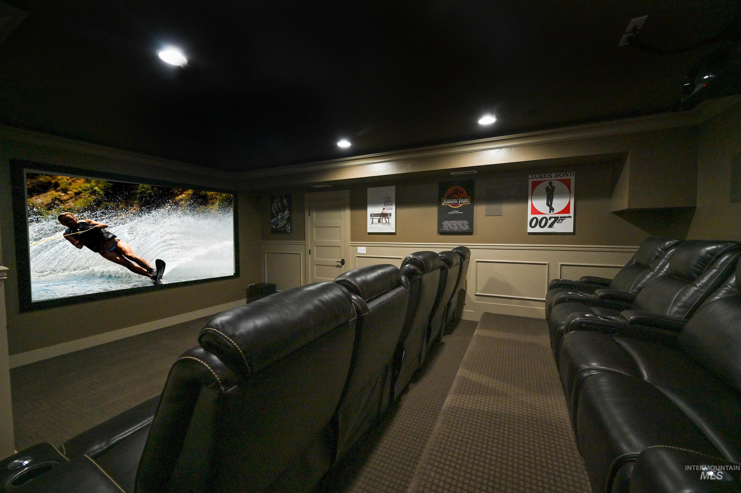Cinema room featuring ornamental molding and recessed lighting