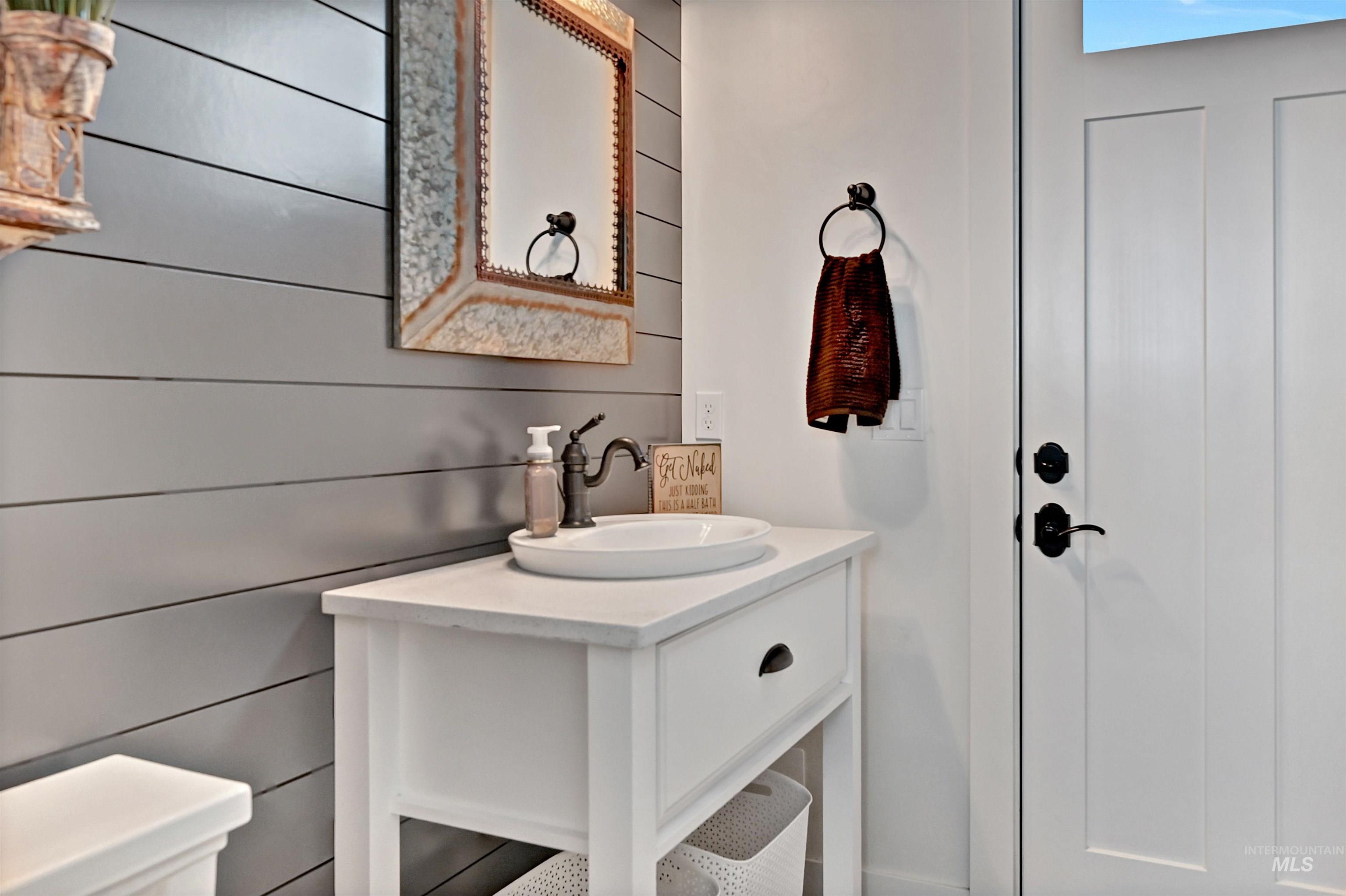 Bathroom with vanity and wooden walls