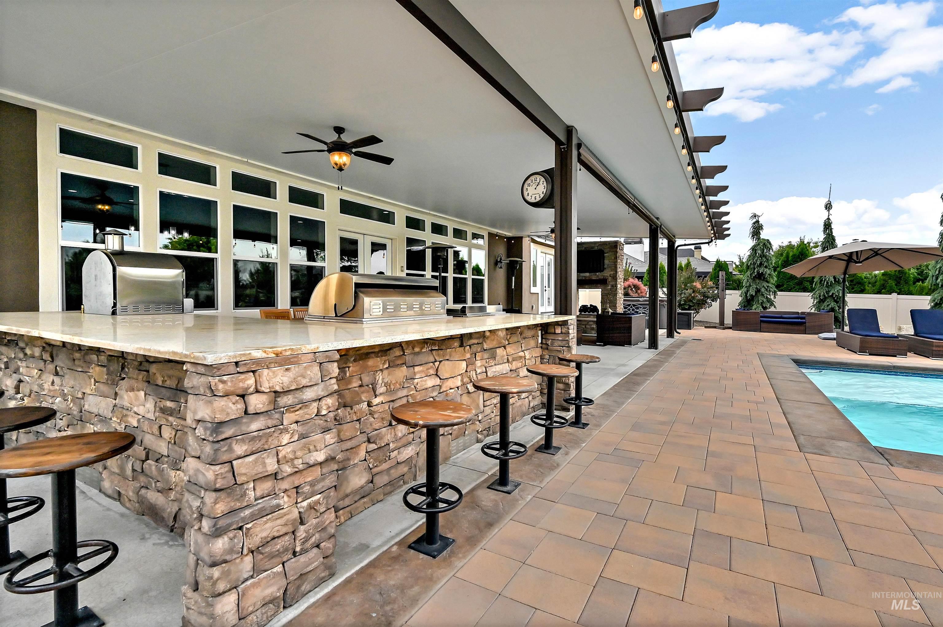 View of patio featuring an outdoor kitchen and ceiling fan