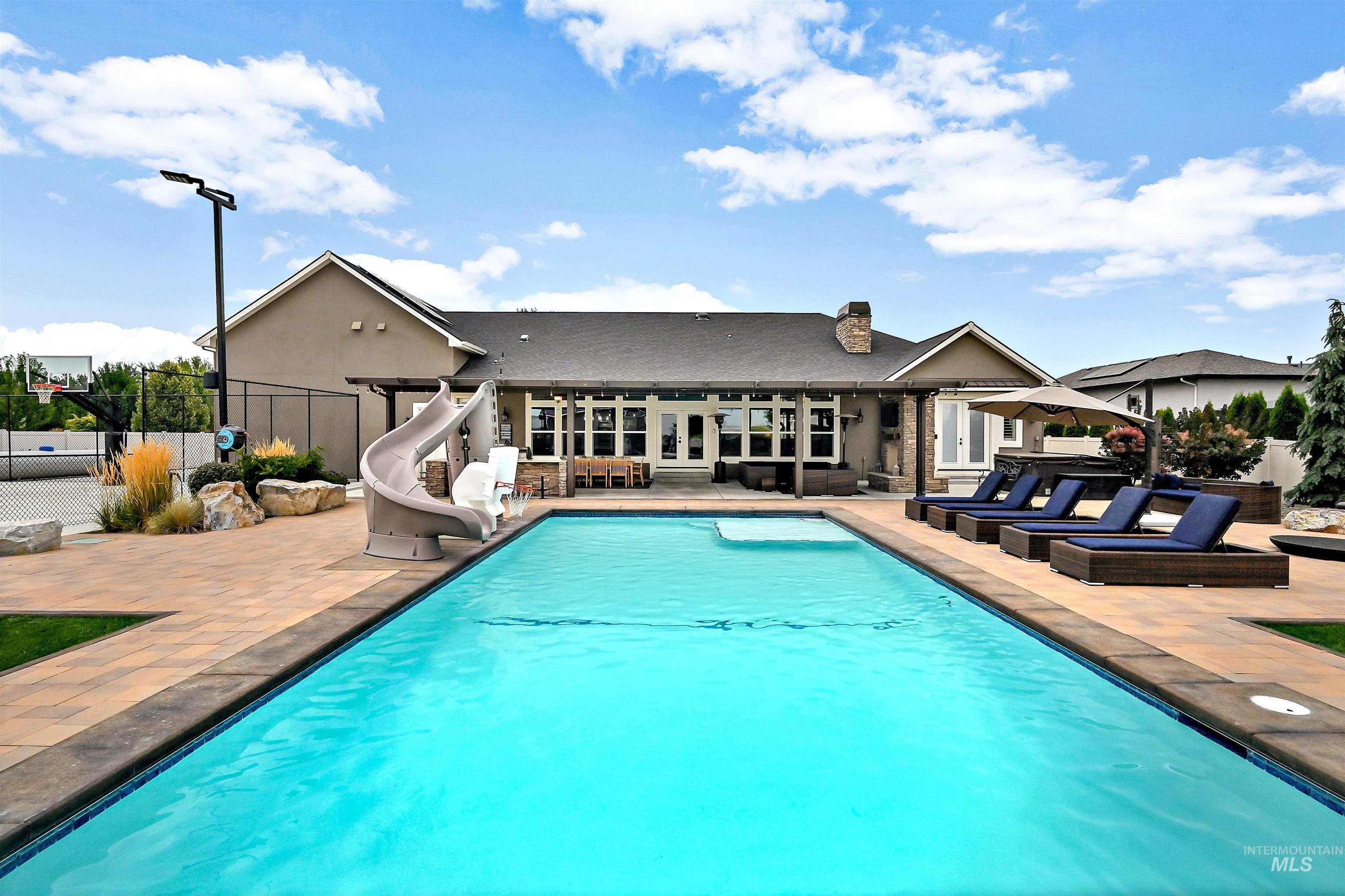 View of pool with a patio, a water slide, and french doors