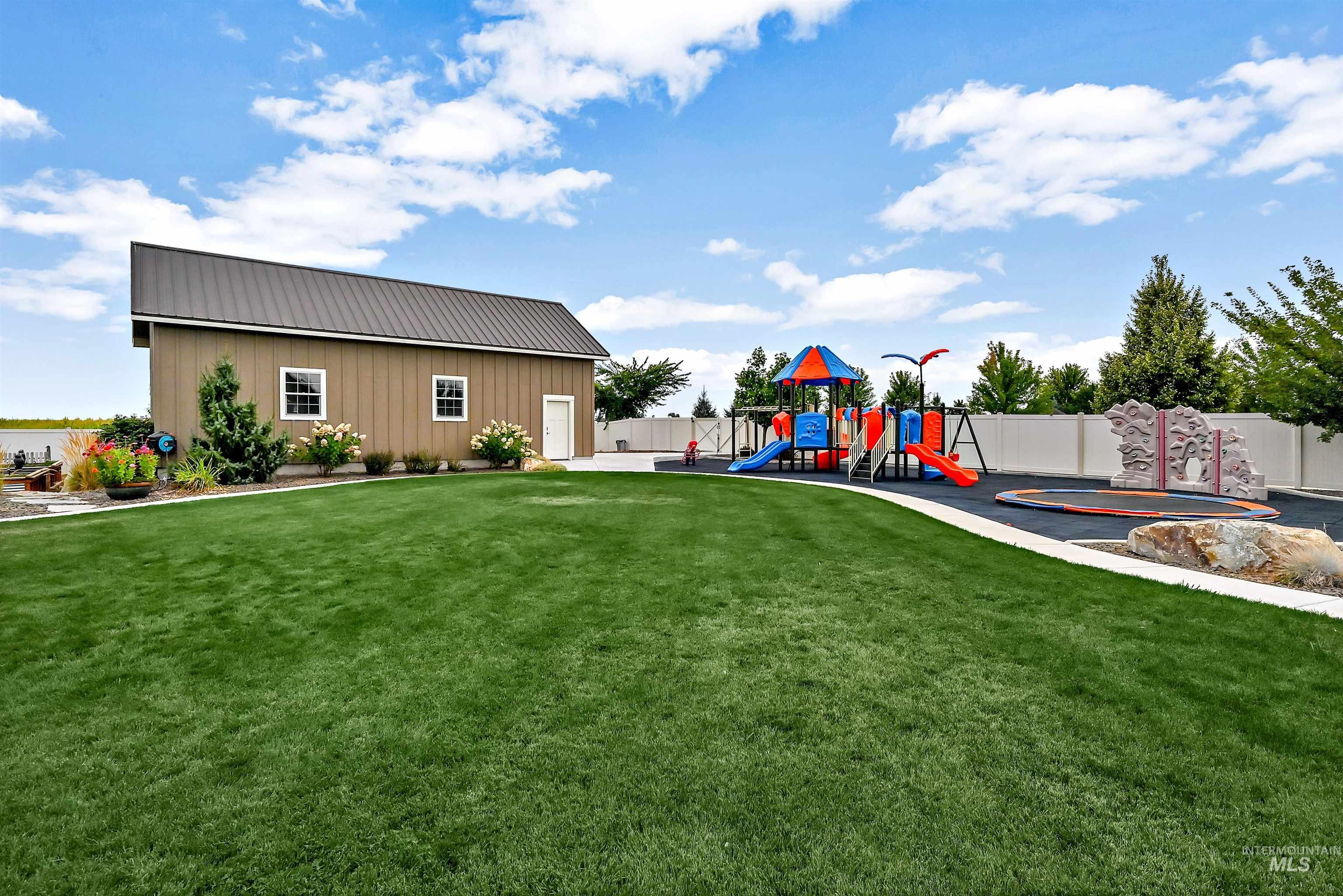 View of yard with a playground and an outdoor structure