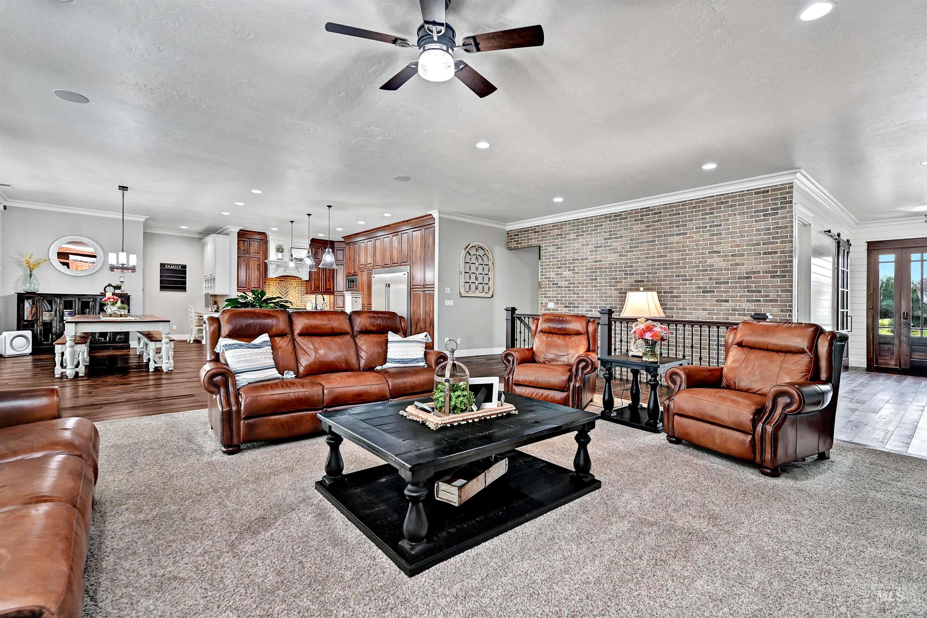 Living area featuring ornamental molding, brick wall, a ceiling fan, recessed lighting, and french doors