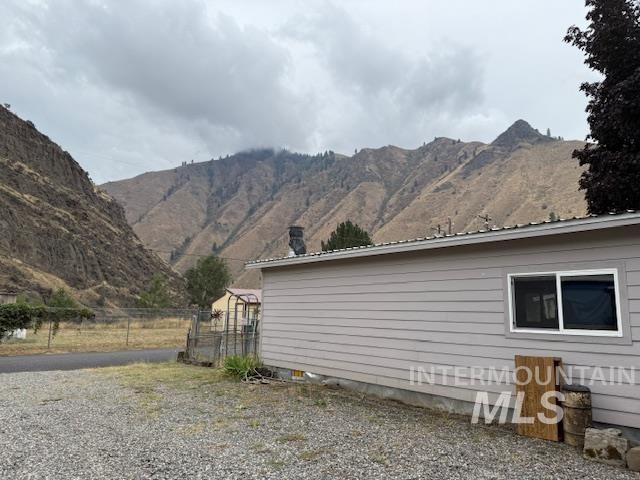 View of side of property with a mountain view
