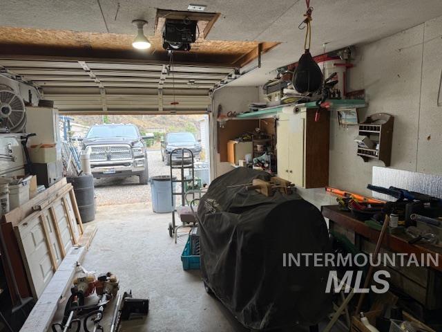 Garage featuring a workshop area and a garage door opener