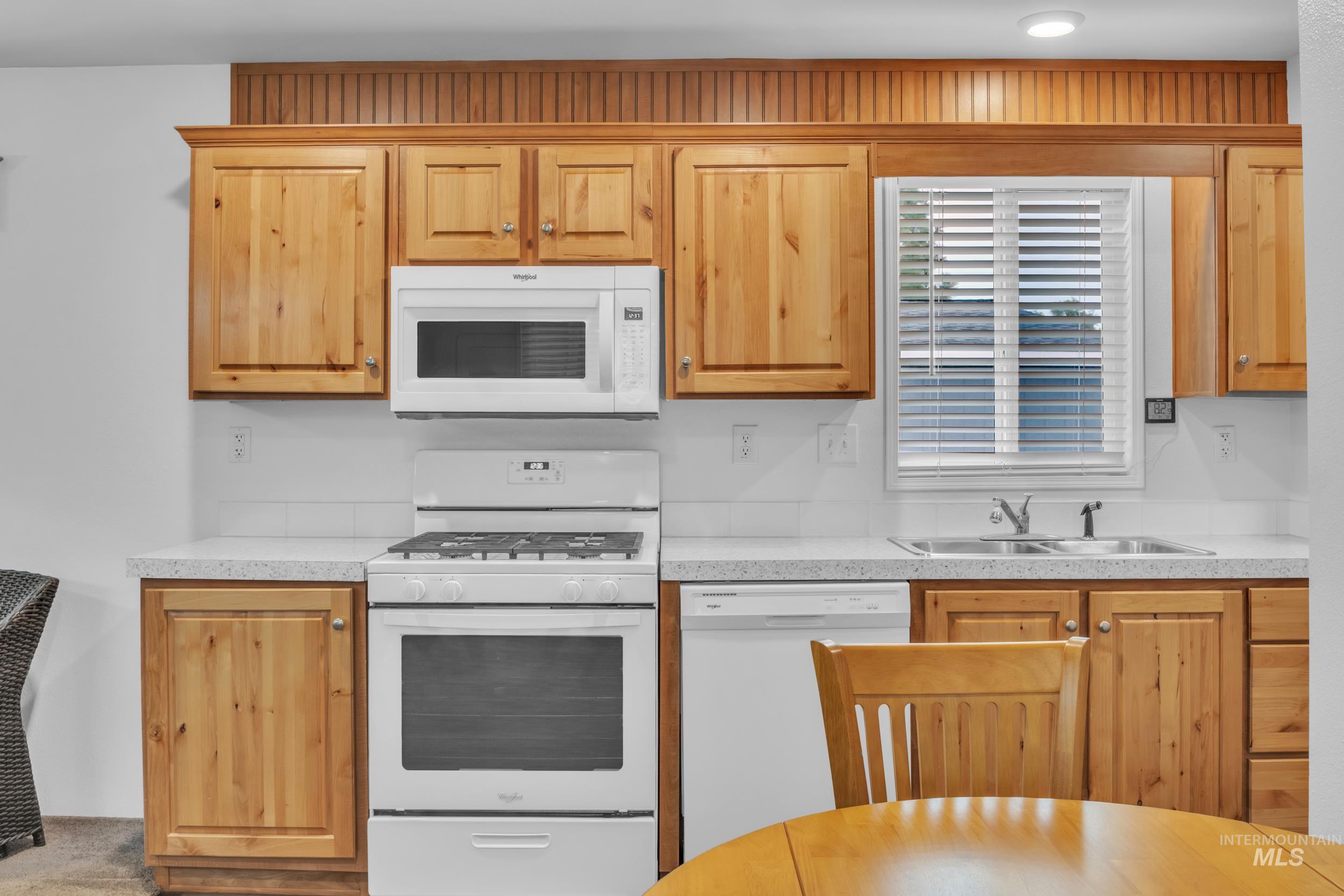 Kitchen with white appliances and light countertops