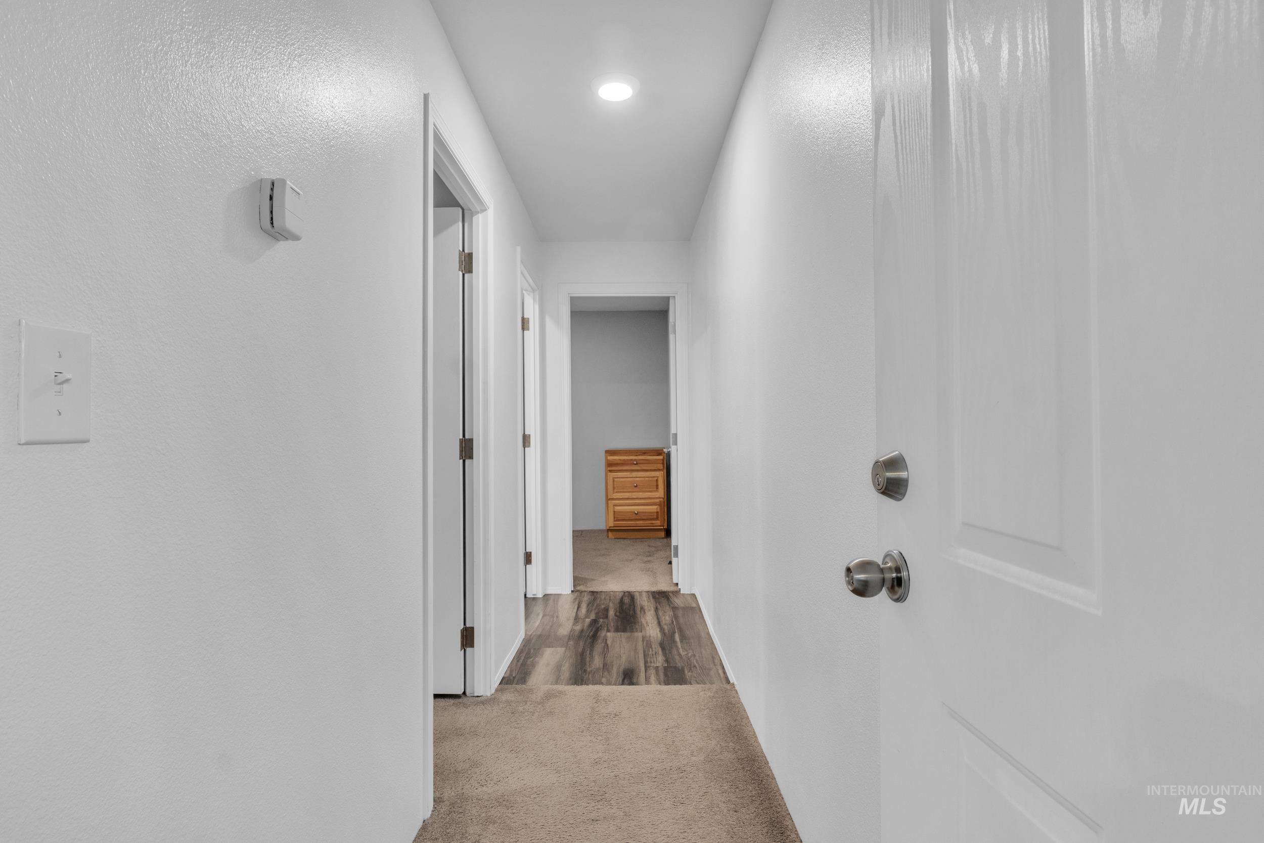 Hallway with carpet and recessed lighting