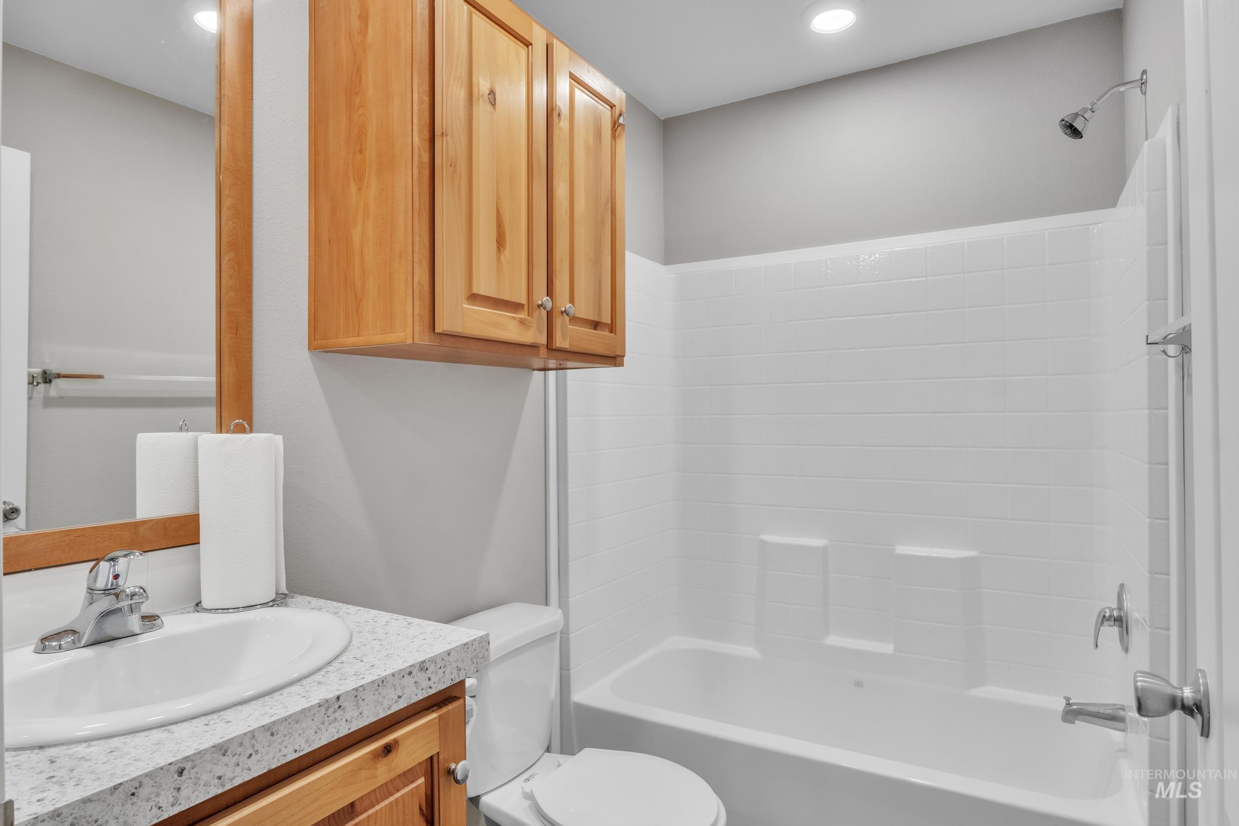 Bathroom with shower / washtub combination and vanity