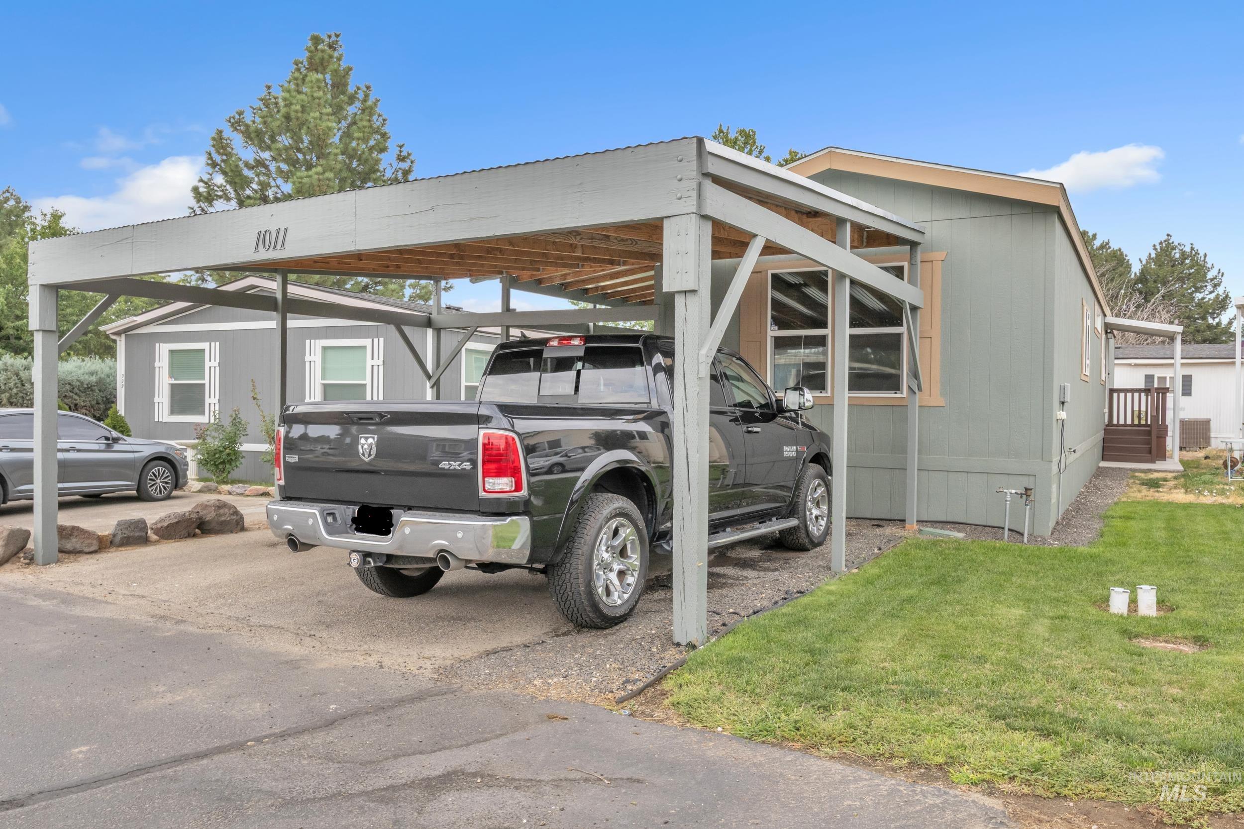 View of vehicle parking featuring a carport