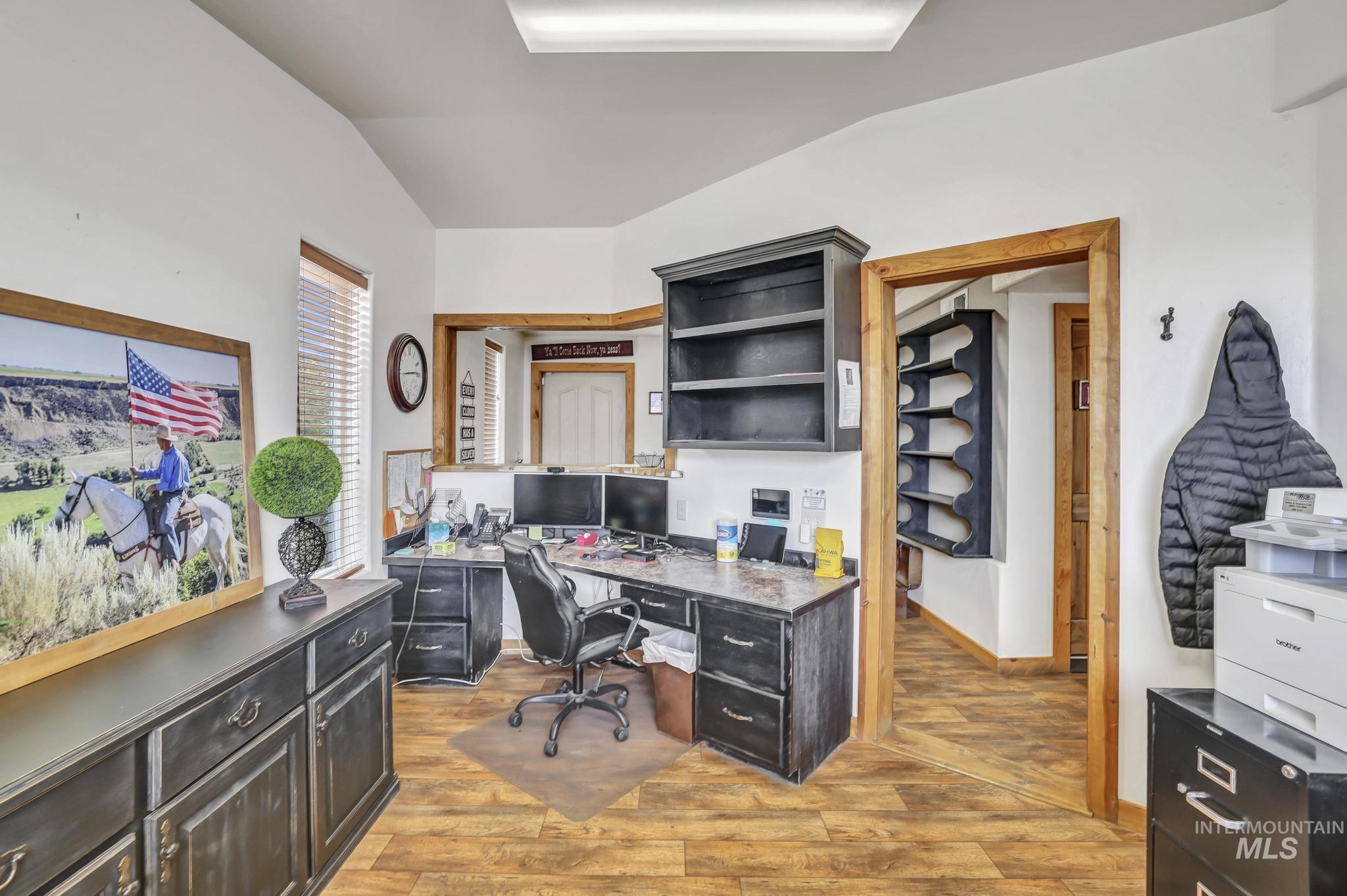 Office area featuring lofted ceiling and light wood finished floors