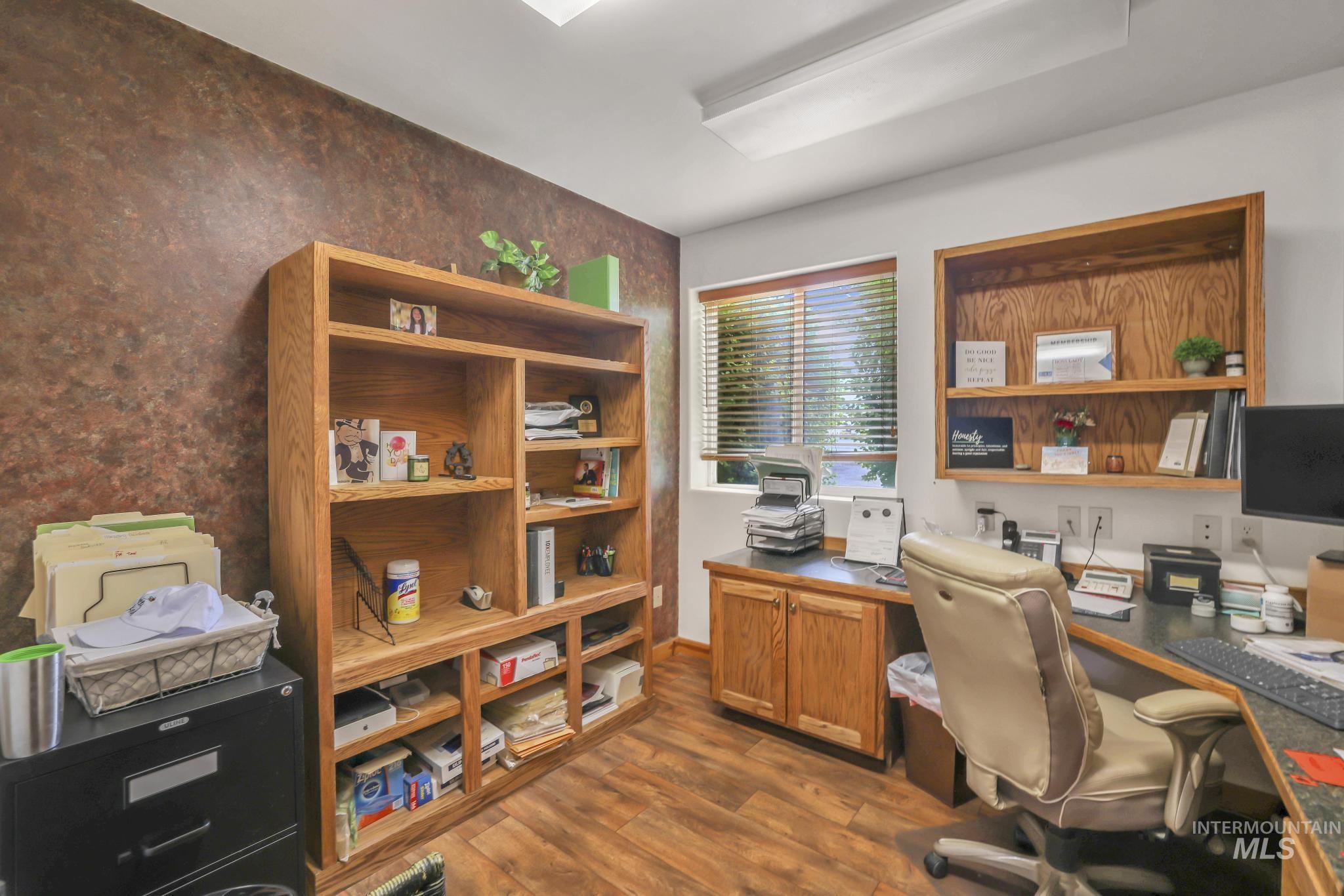 Office featuring dark wood-type flooring and baseboards