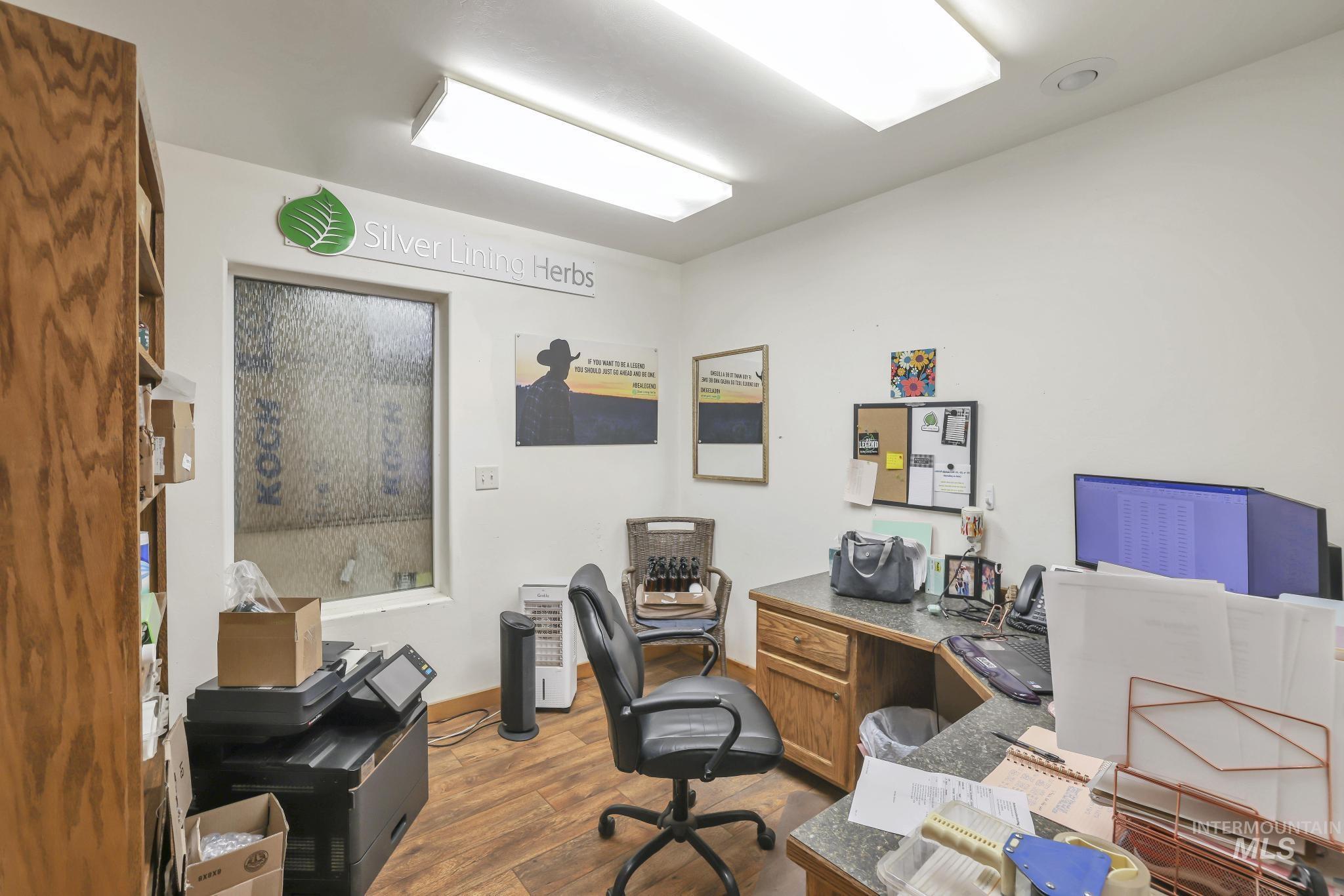 Office space featuring dark wood-style floors and baseboards