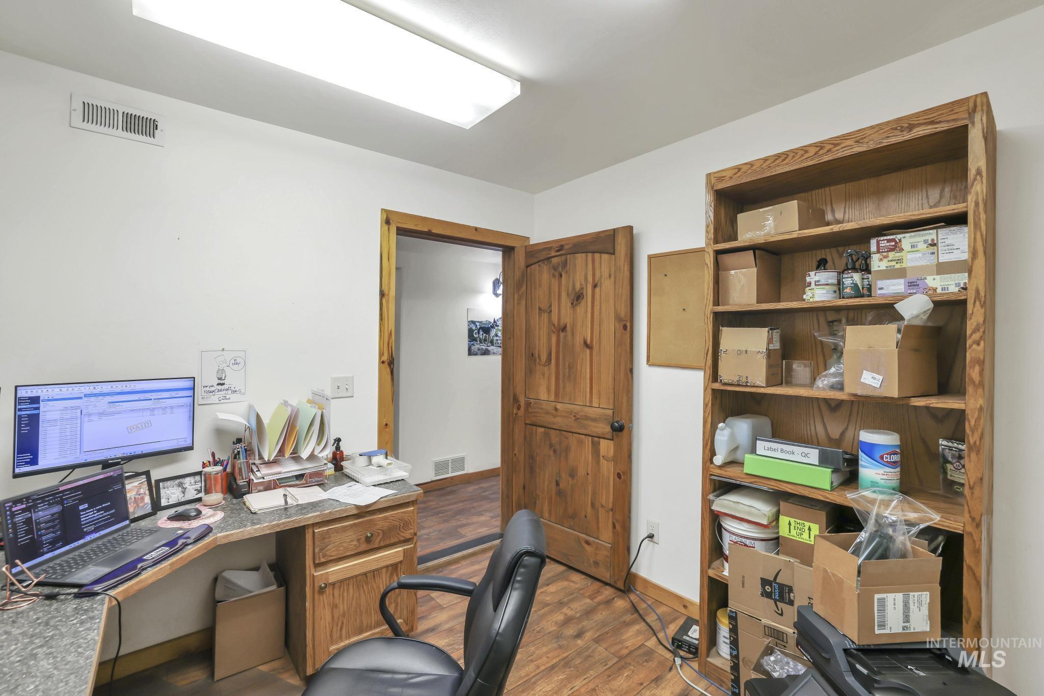 Office area with wood finished floors and baseboards