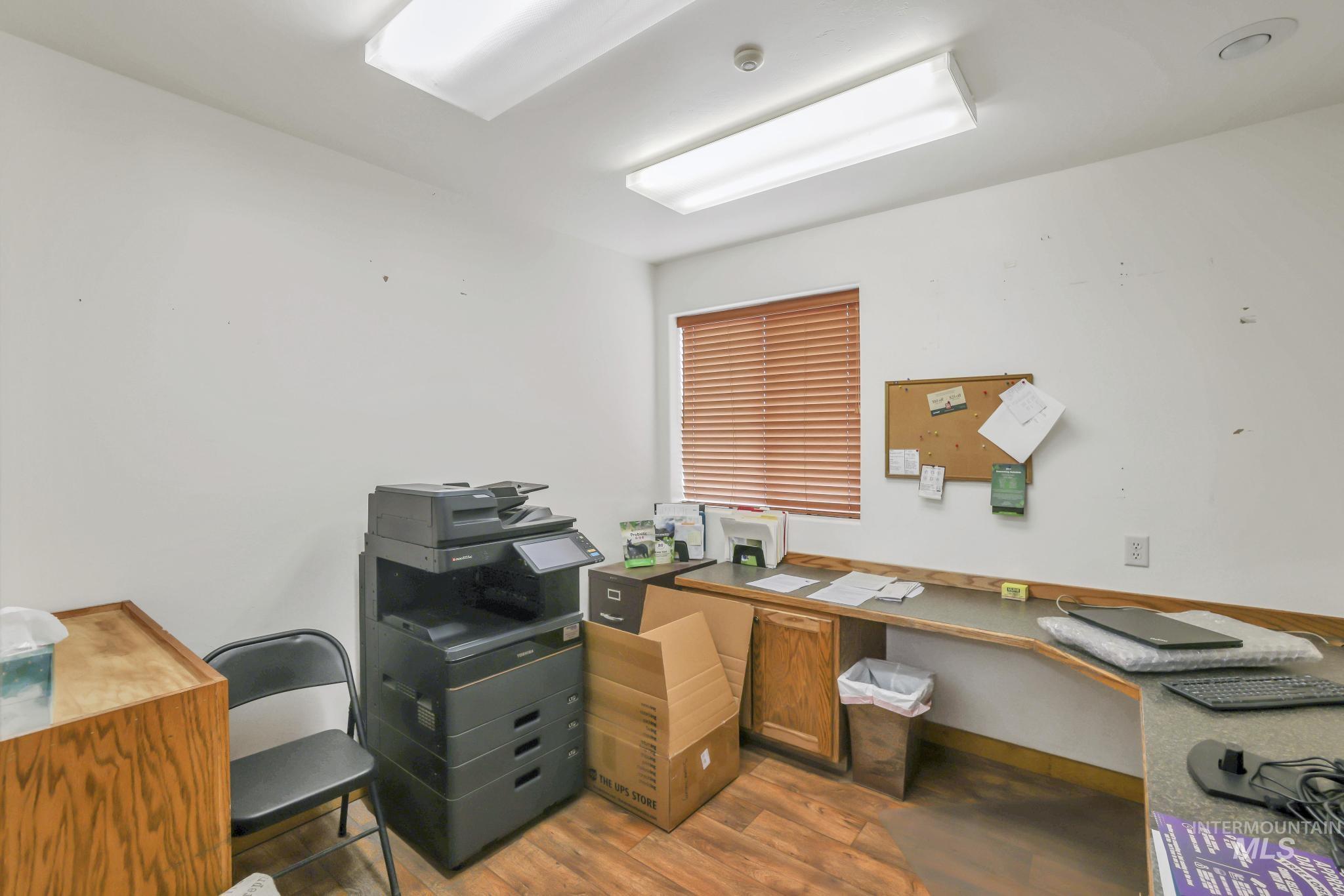 Office area featuring light wood-style floors