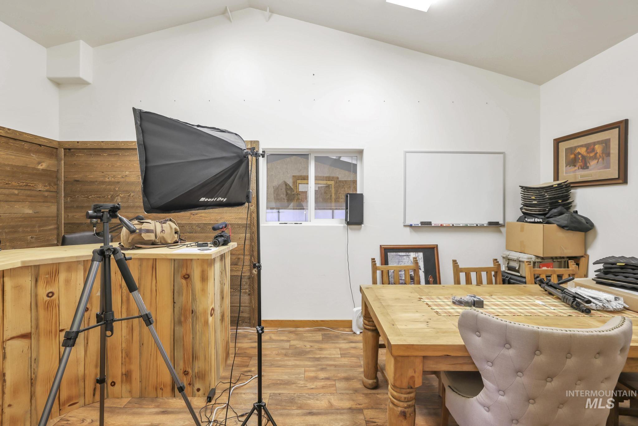 Dining space with light wood finished floors and lofted ceiling
