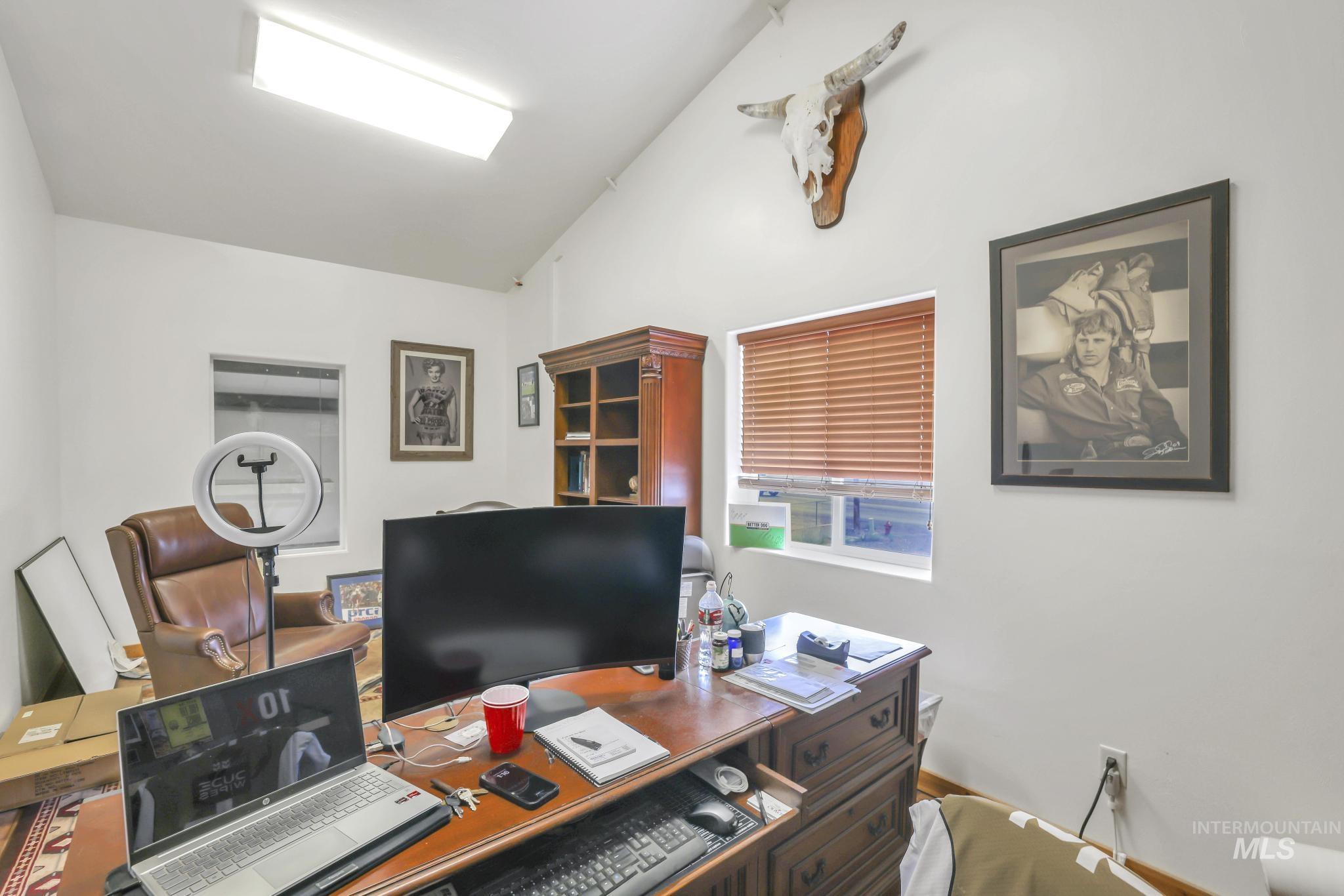 Home office with lofted ceiling