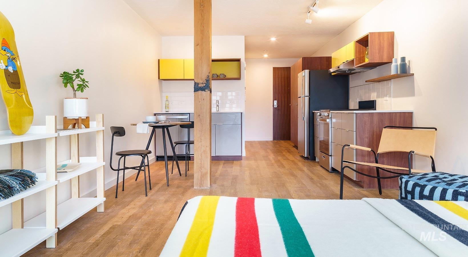 Kitchen featuring light wood finished floors, modern cabinets, brown cabinets, and open shelves