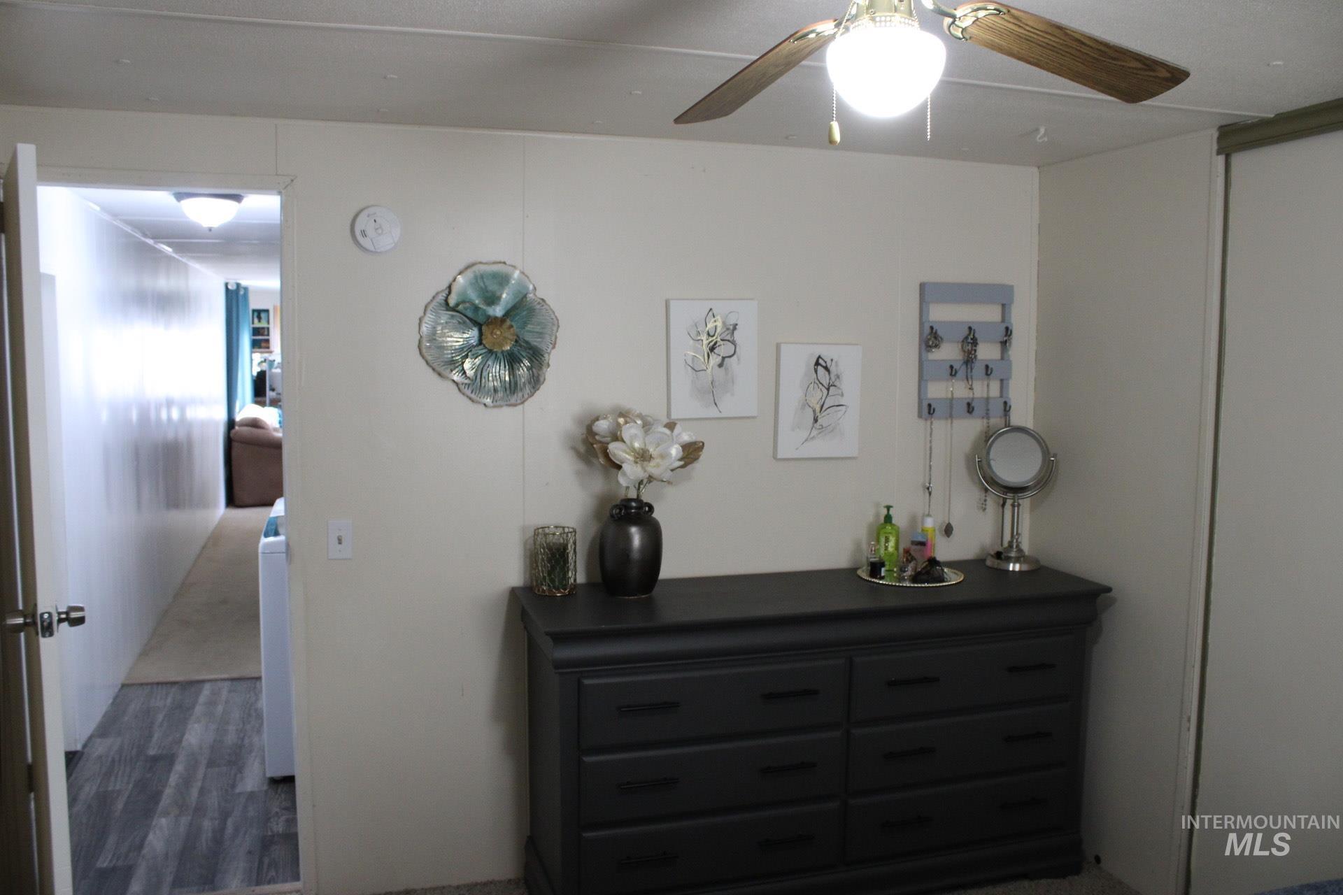 Bedroom featuring ceiling fan and dark wood-style floors