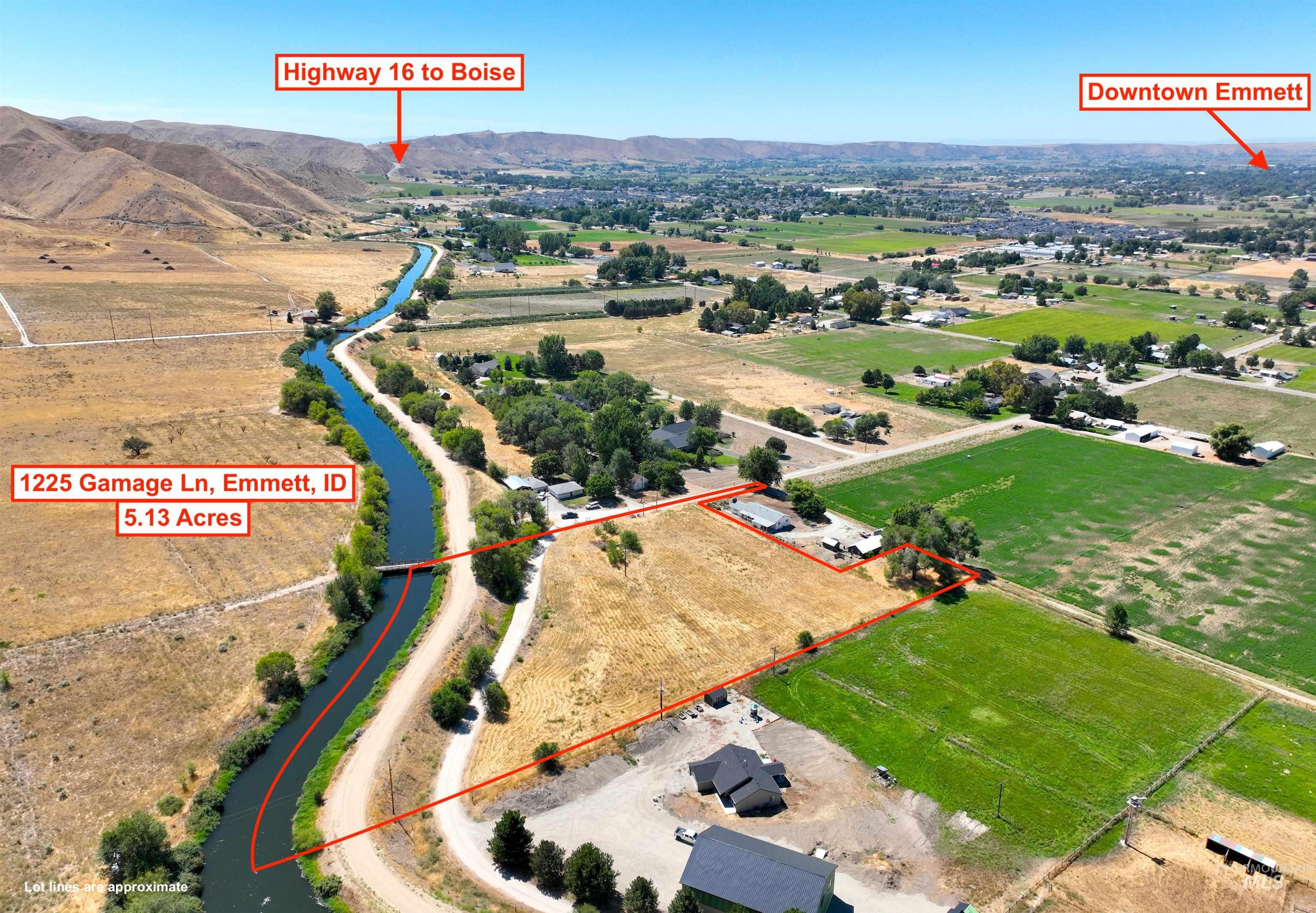 Overview of rural landscape with a mountain backdrop and property parcel outlined