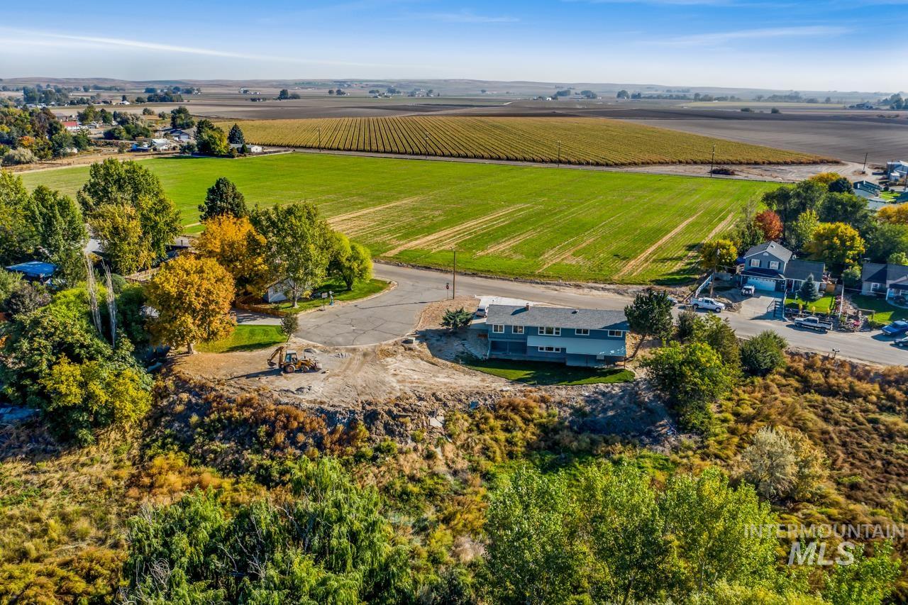 Aerial view of sparsely populated area with large plots for crops