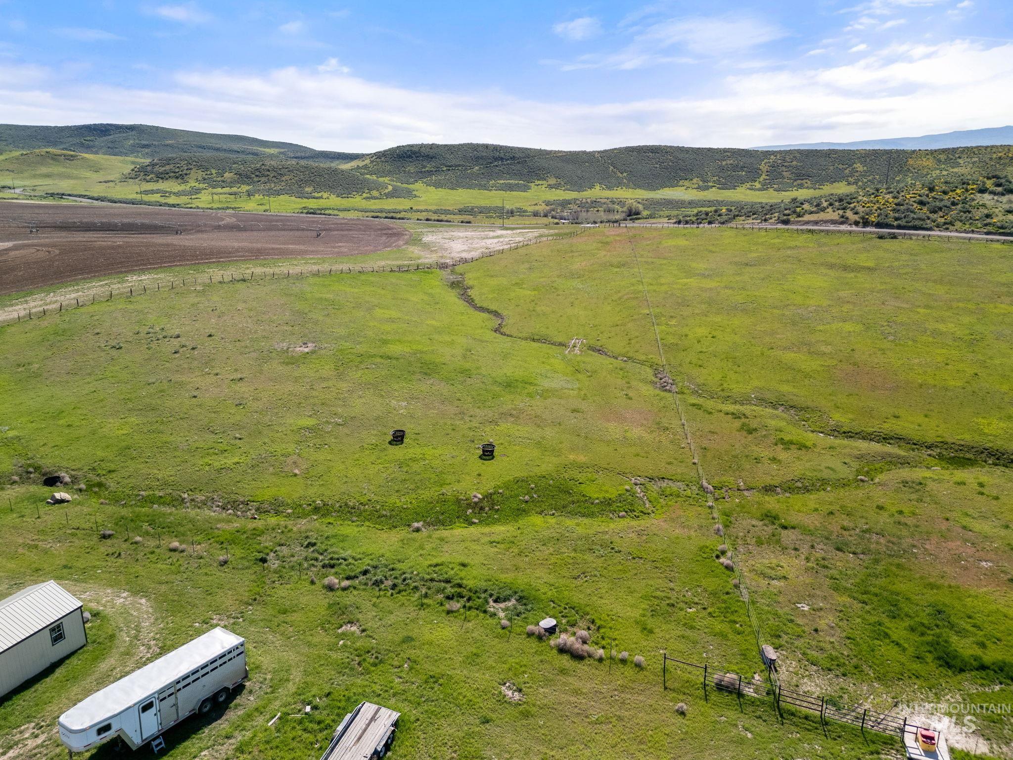 Overview of rural landscape with a pastoral area and a mountain backdrop