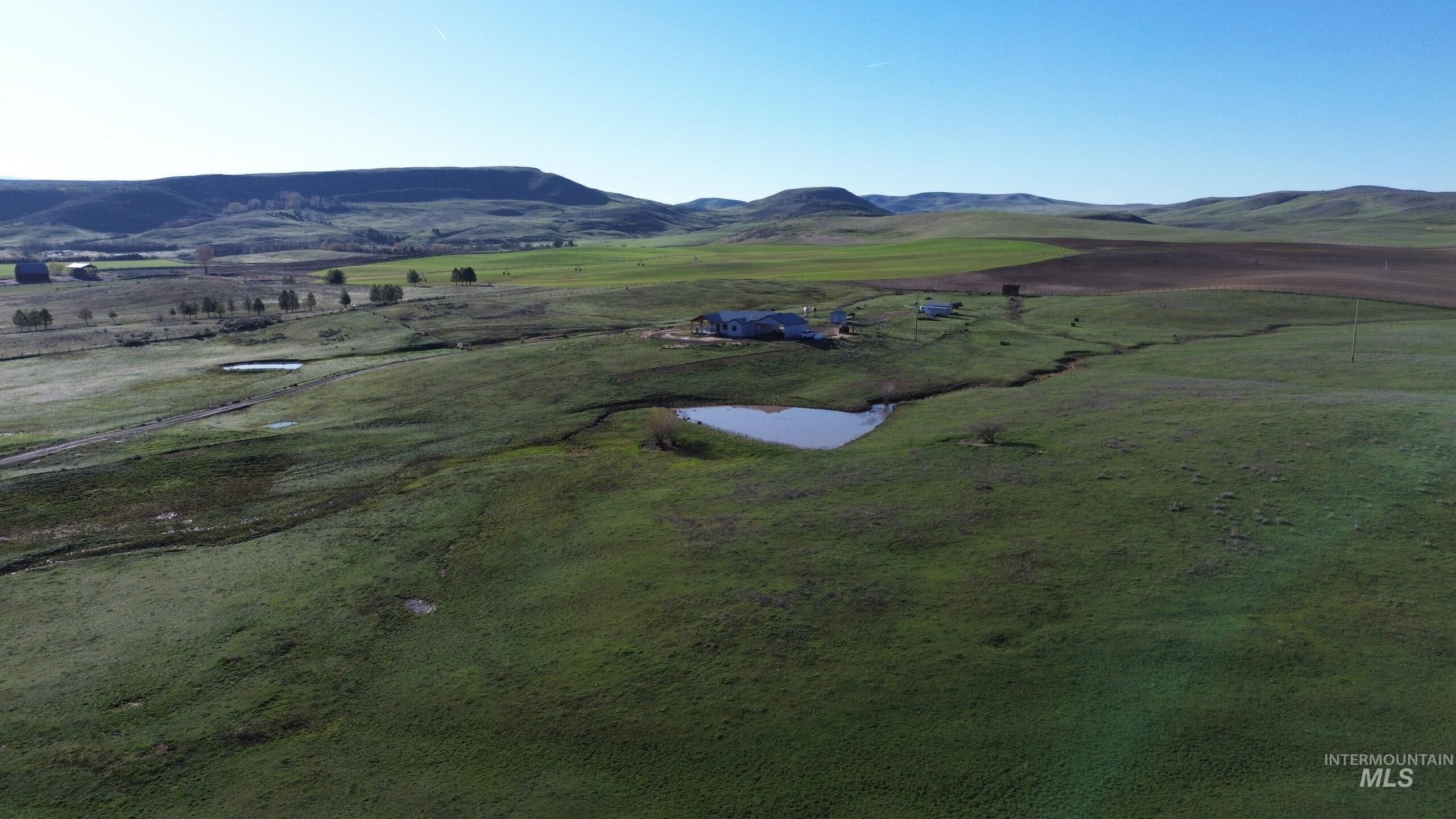 Overview of rural landscape featuring a water and mountain view