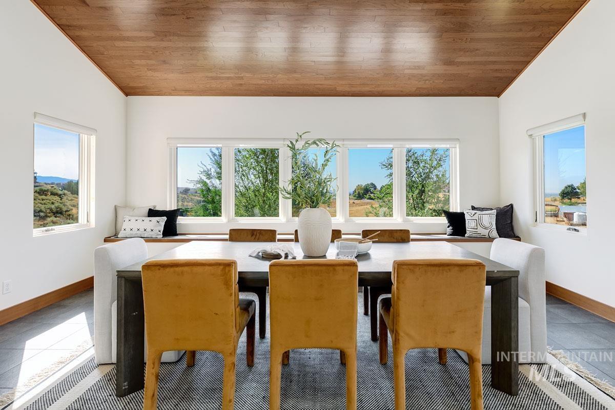 Tiled dining area with wooden ceiling and vaulted ceiling