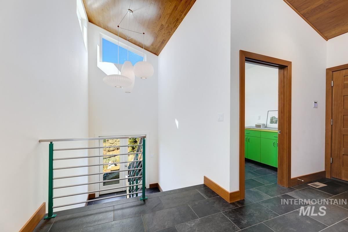 Interior space with wooden ceiling and high vaulted ceiling