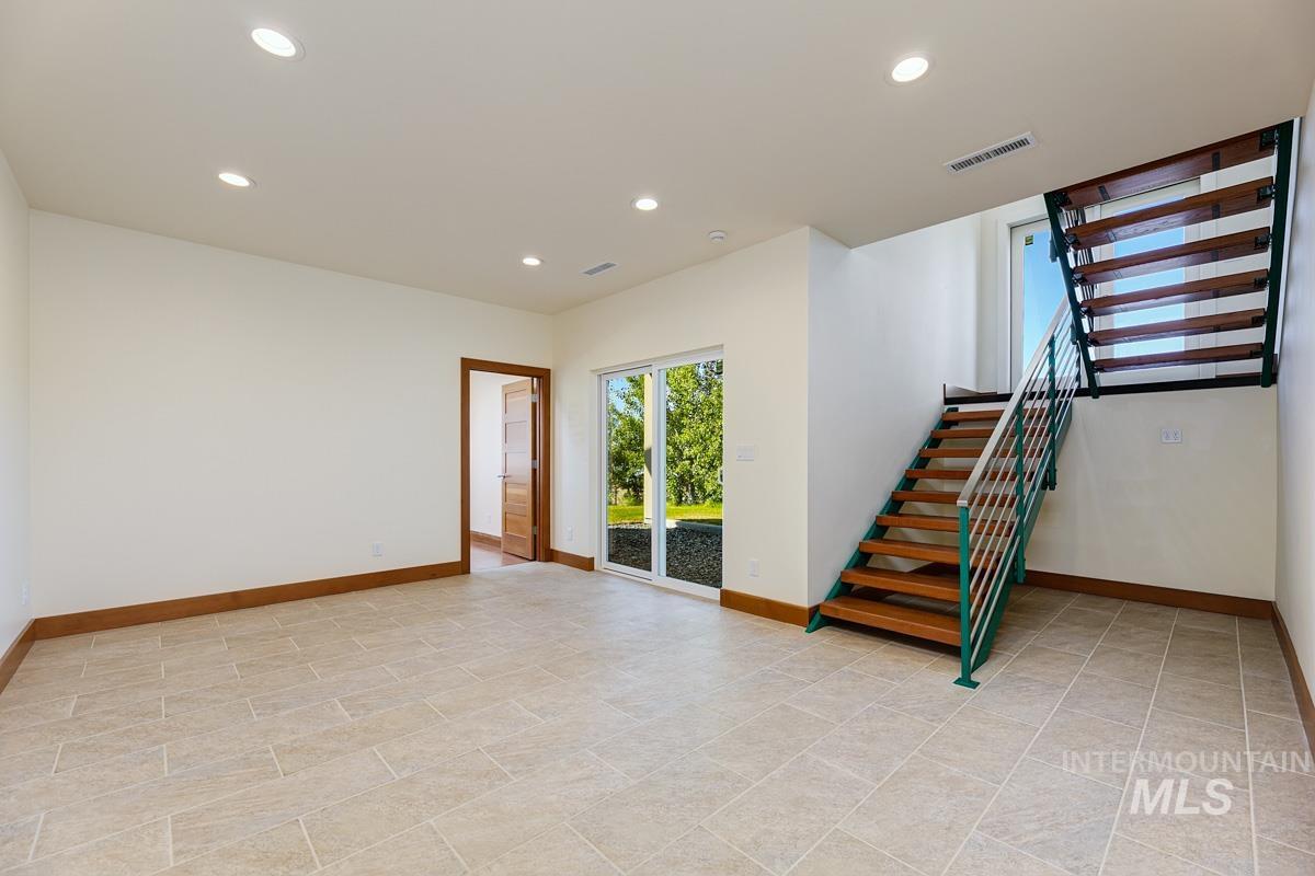 Spare room featuring stairway and recessed lighting
