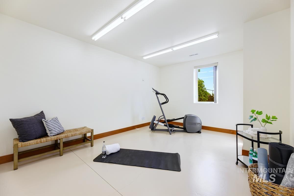 Workout area featuring baseboards