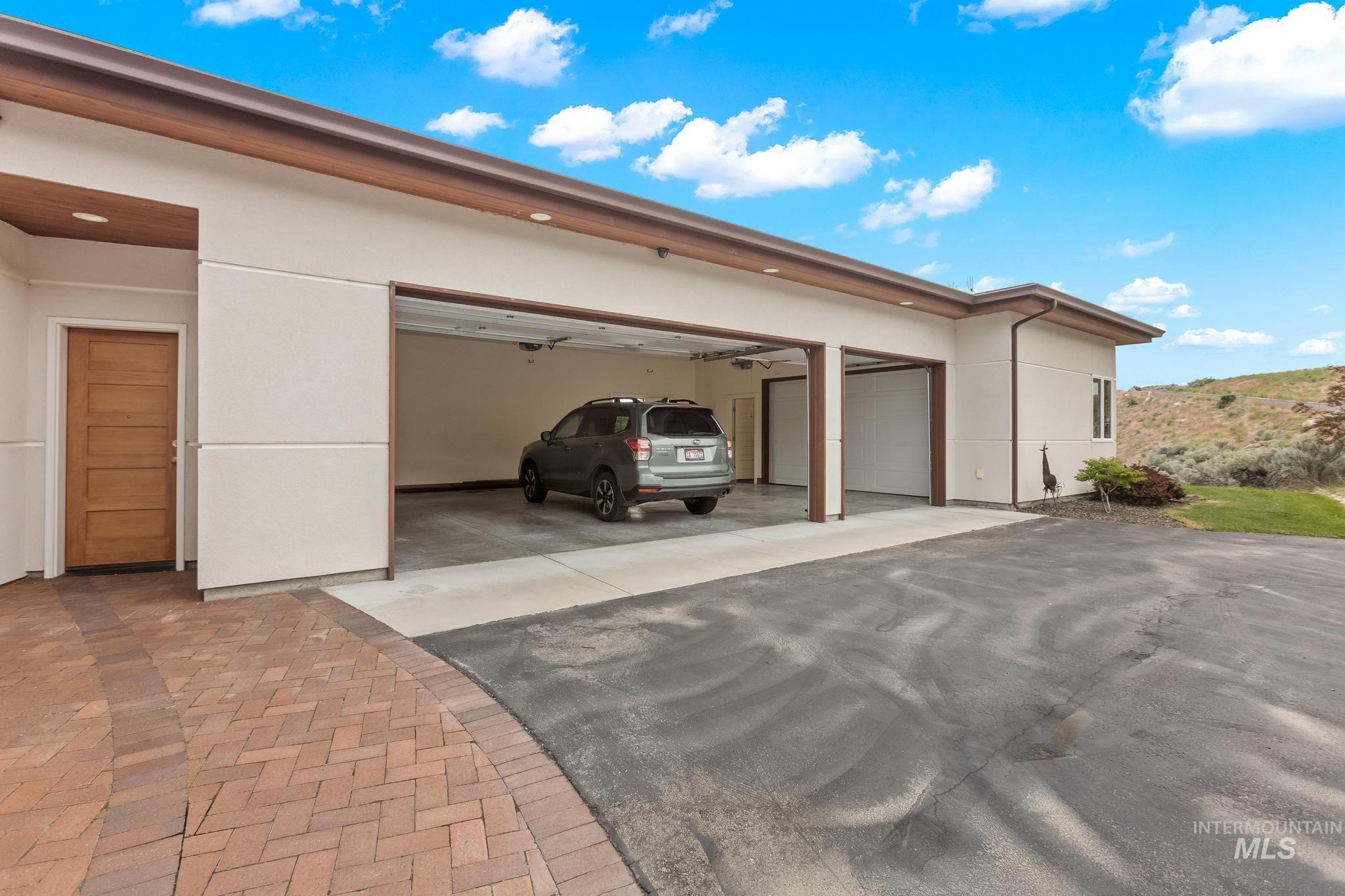 Garage featuring asphalt driveway
