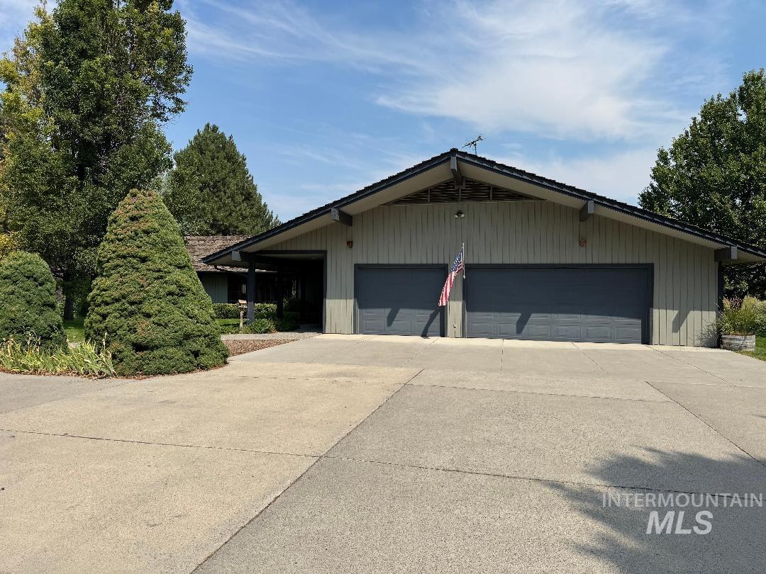 Garage featuring concrete driveway
