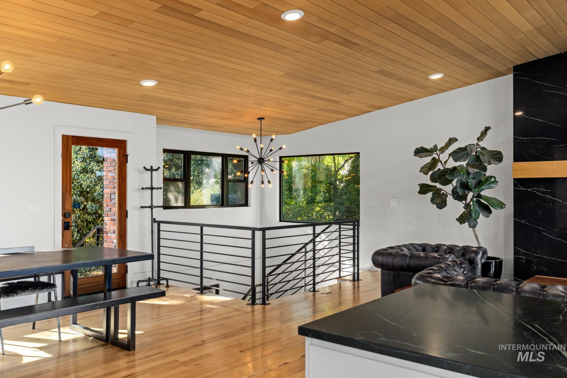 Dining area with light wood finished floors, wood ceiling, recessed lighting, and a chandelier