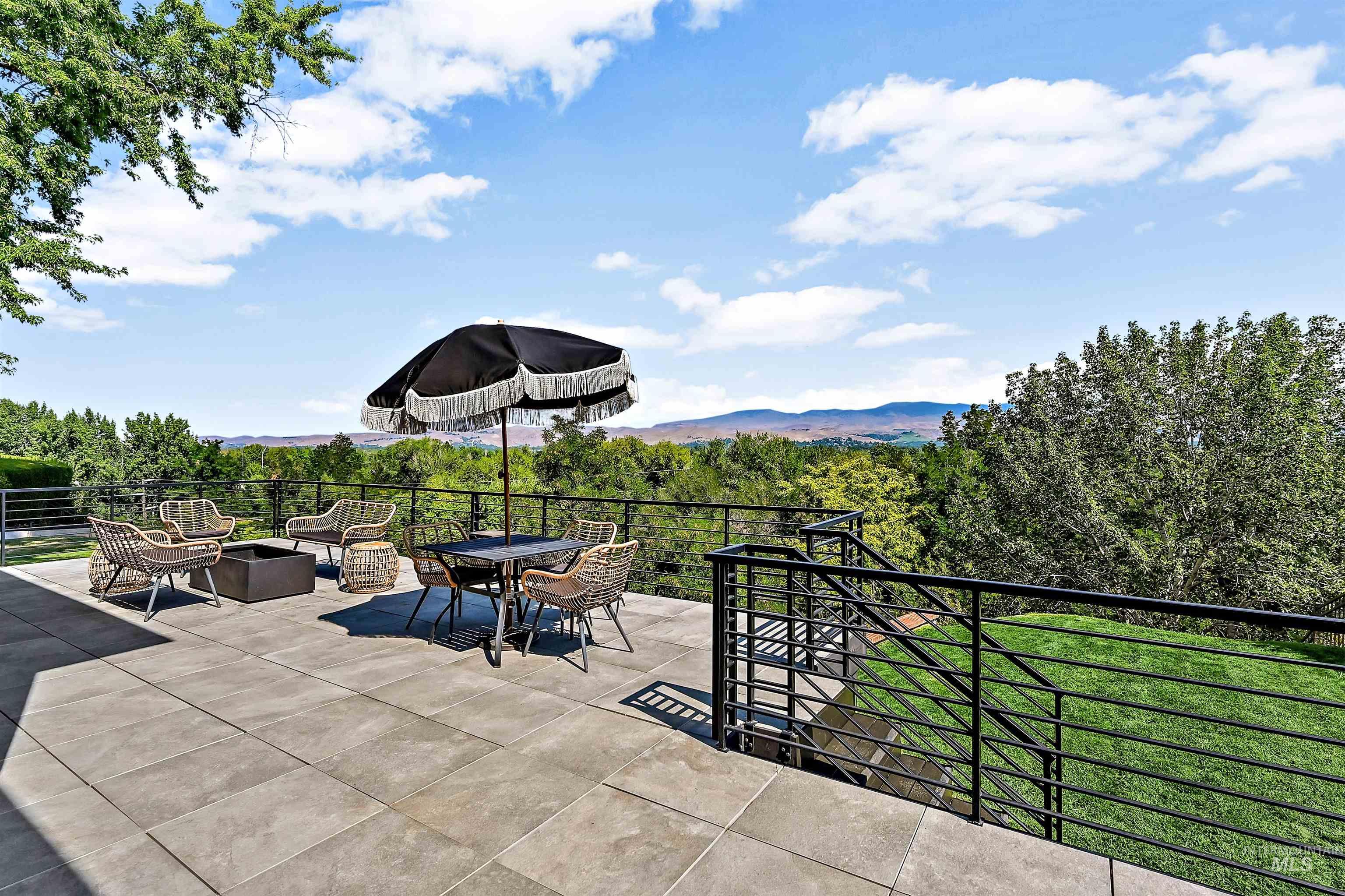 View of patio featuring a wooded view and an outdoor fire pit