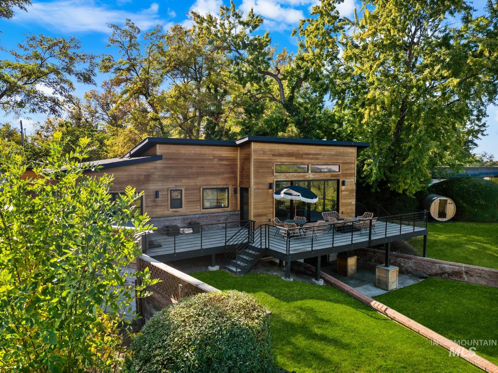 Back of house featuring a wooden deck and a yard