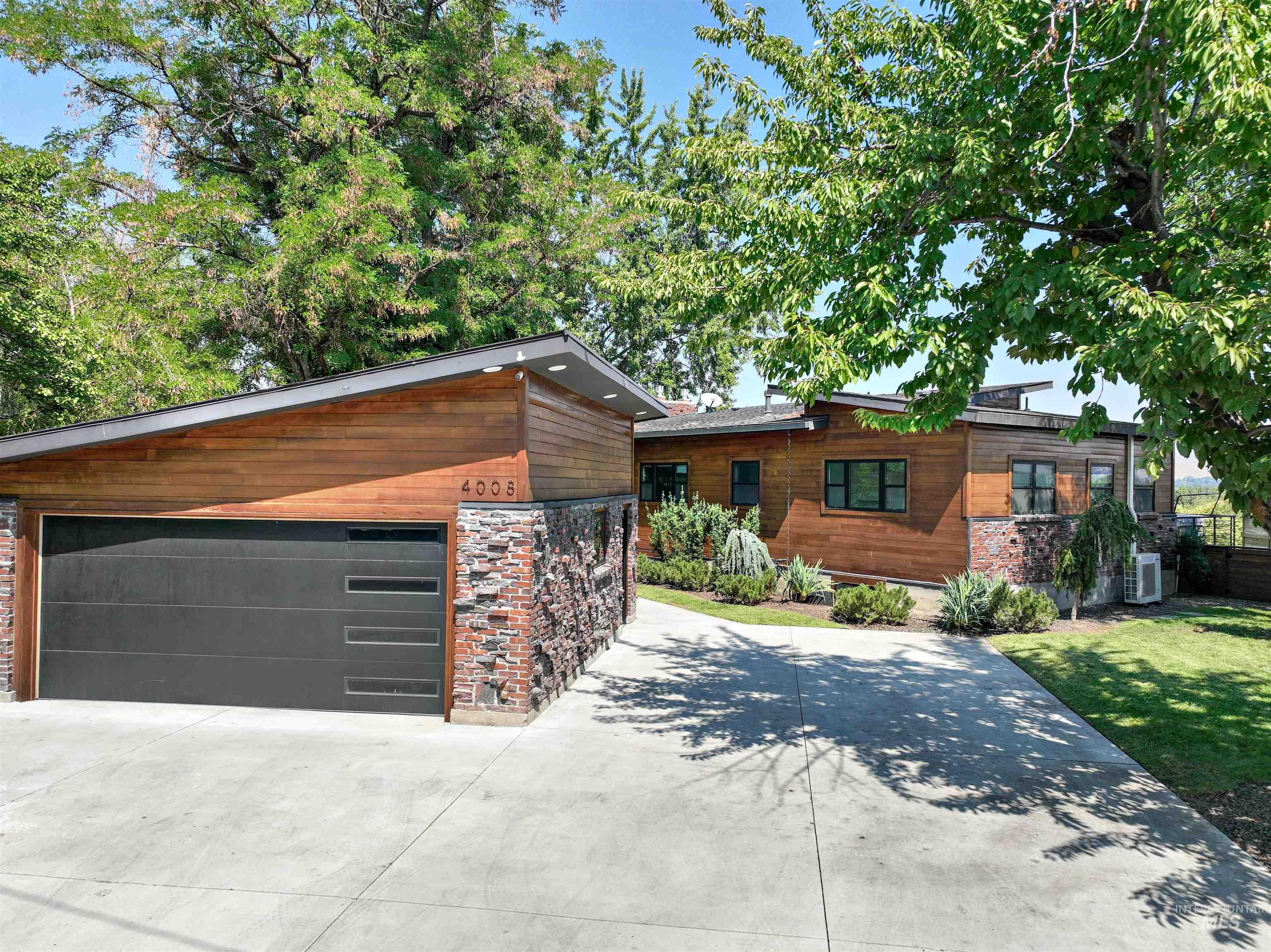 Modern home with an outdoor structure and a garage