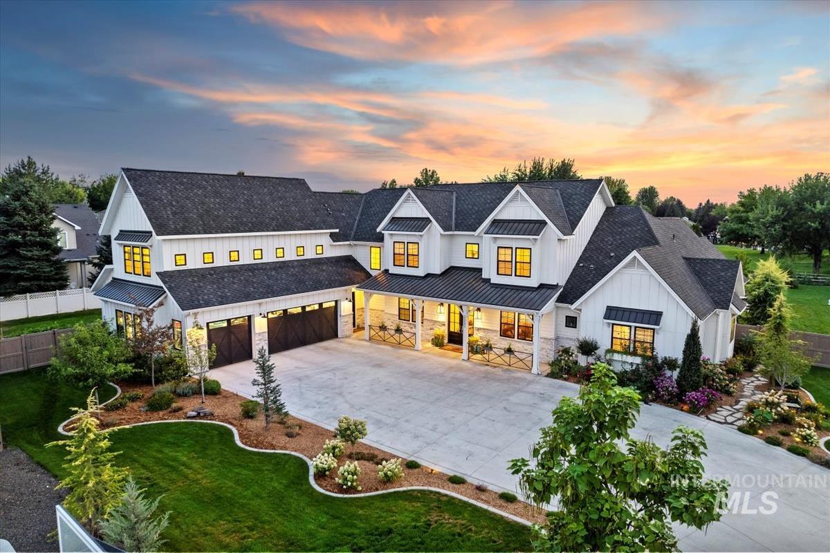 Modern inspired farmhouse with board and batten siding, a standing seam roof, a metal roof, a porch, and roof with shingles