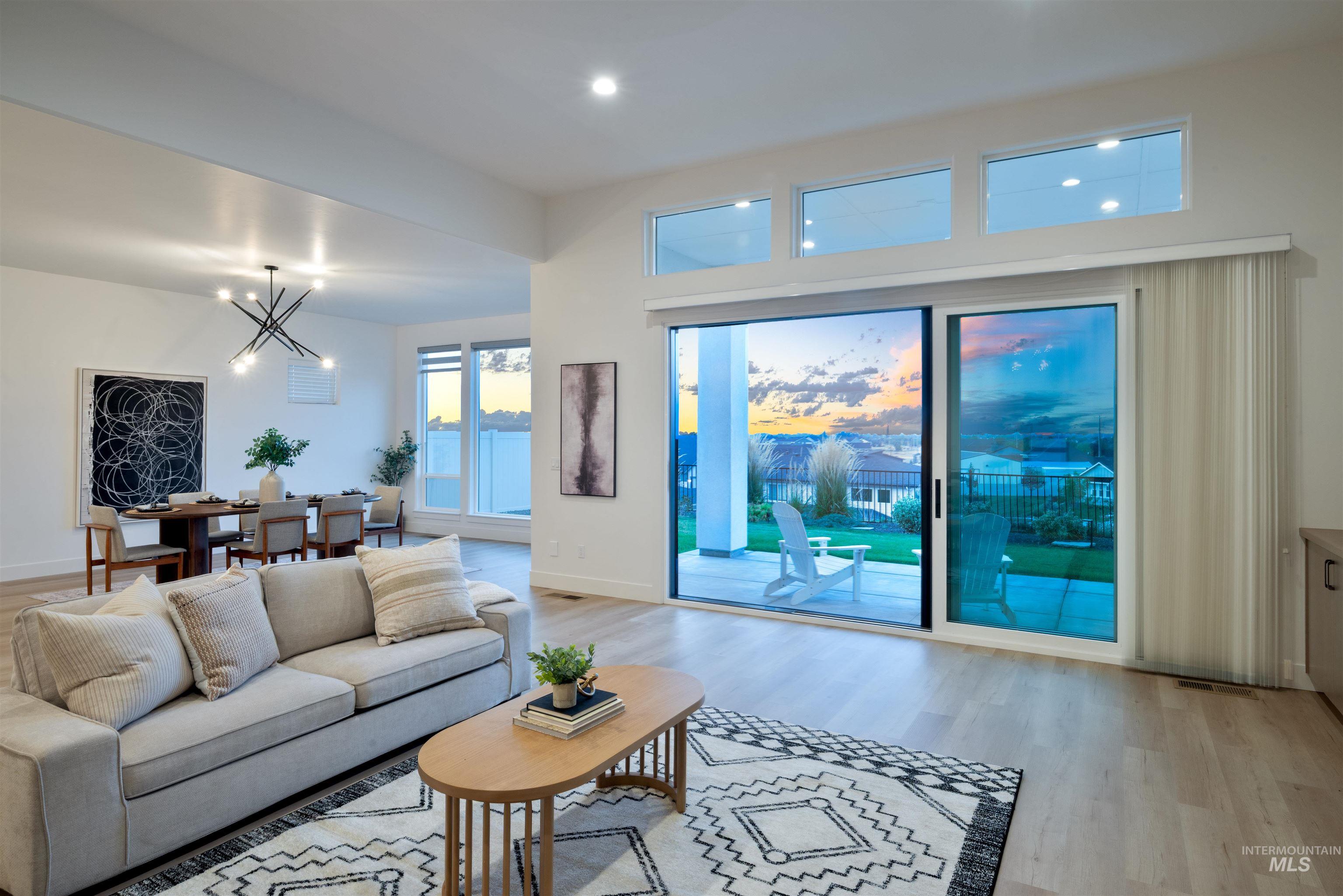 Living area featuring light wood-style flooring, a chandelier, and recessed lighting