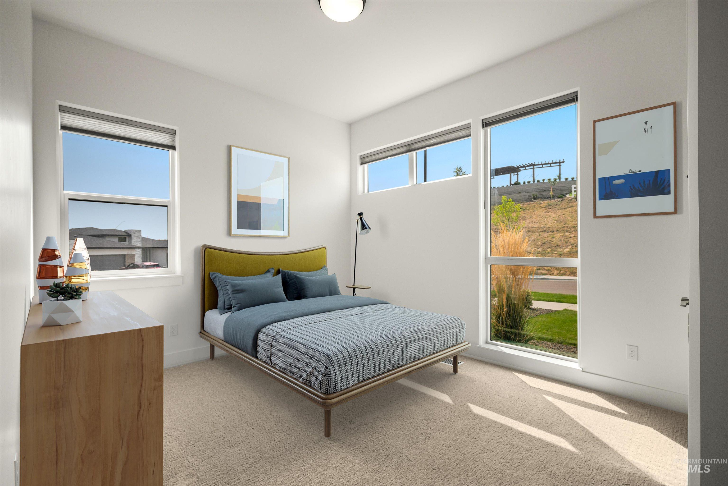 Bedroom featuring light carpet and baseboards